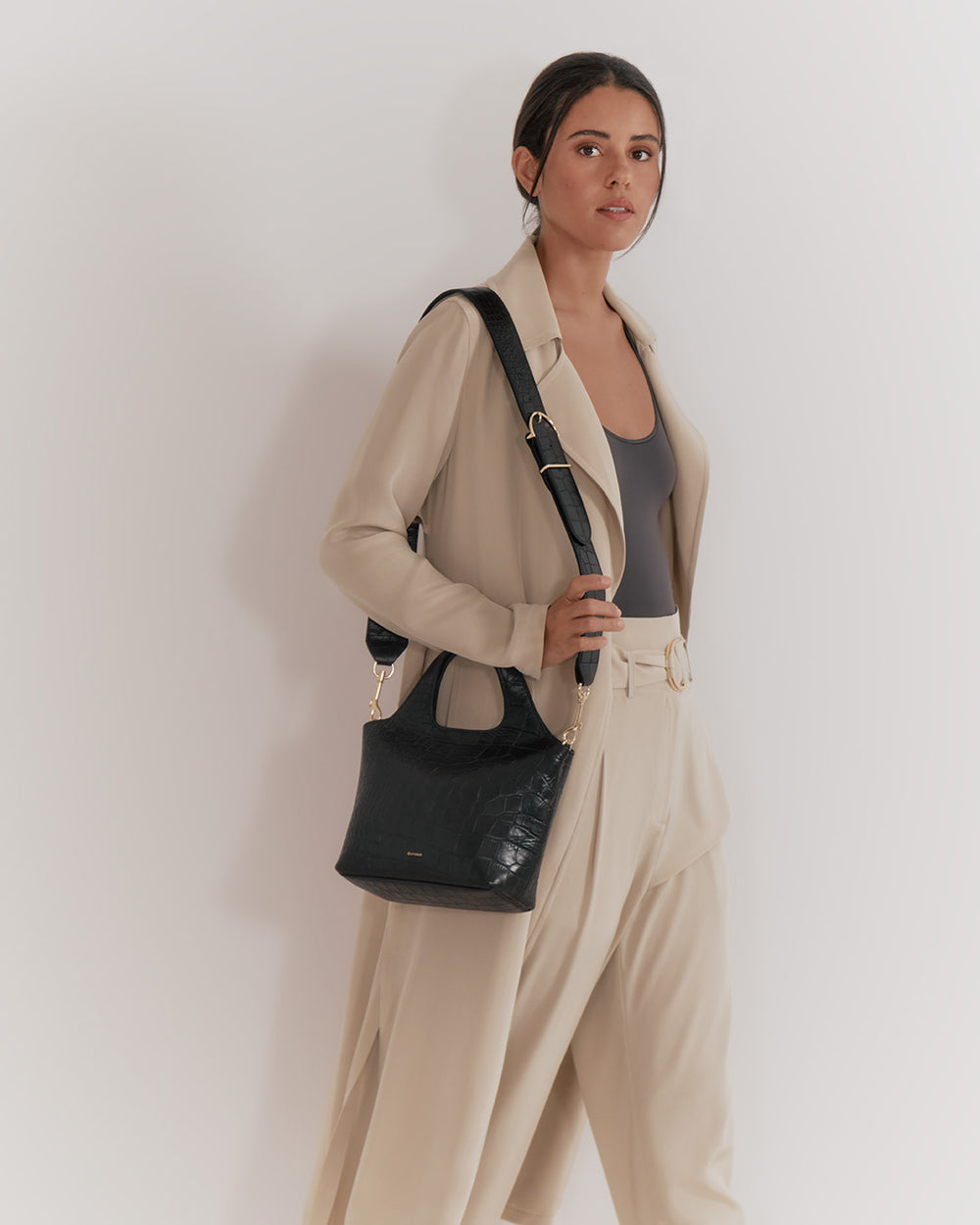 Woman in professional attire carrying a shoulder bag