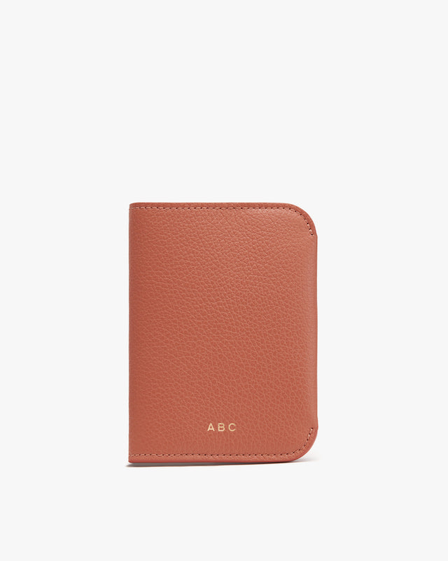 A leather wallet with initials ABC embossed on it.