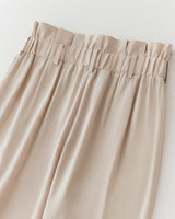 Close-up of a skirt with ruffled waistband.