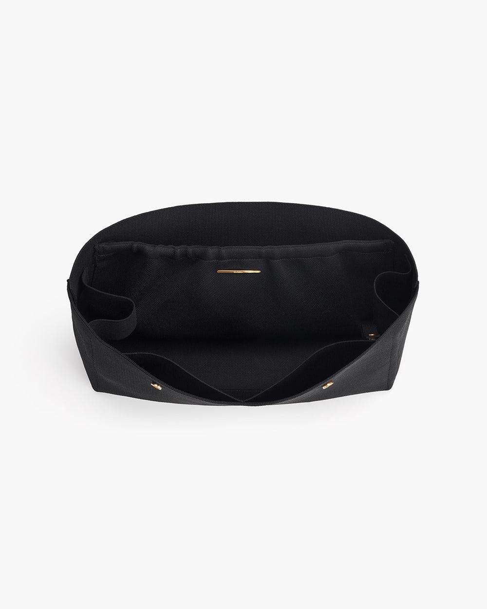Open black handbag with pockets viewed from above.