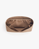 Open fabric organizer with compartments on a plain background.