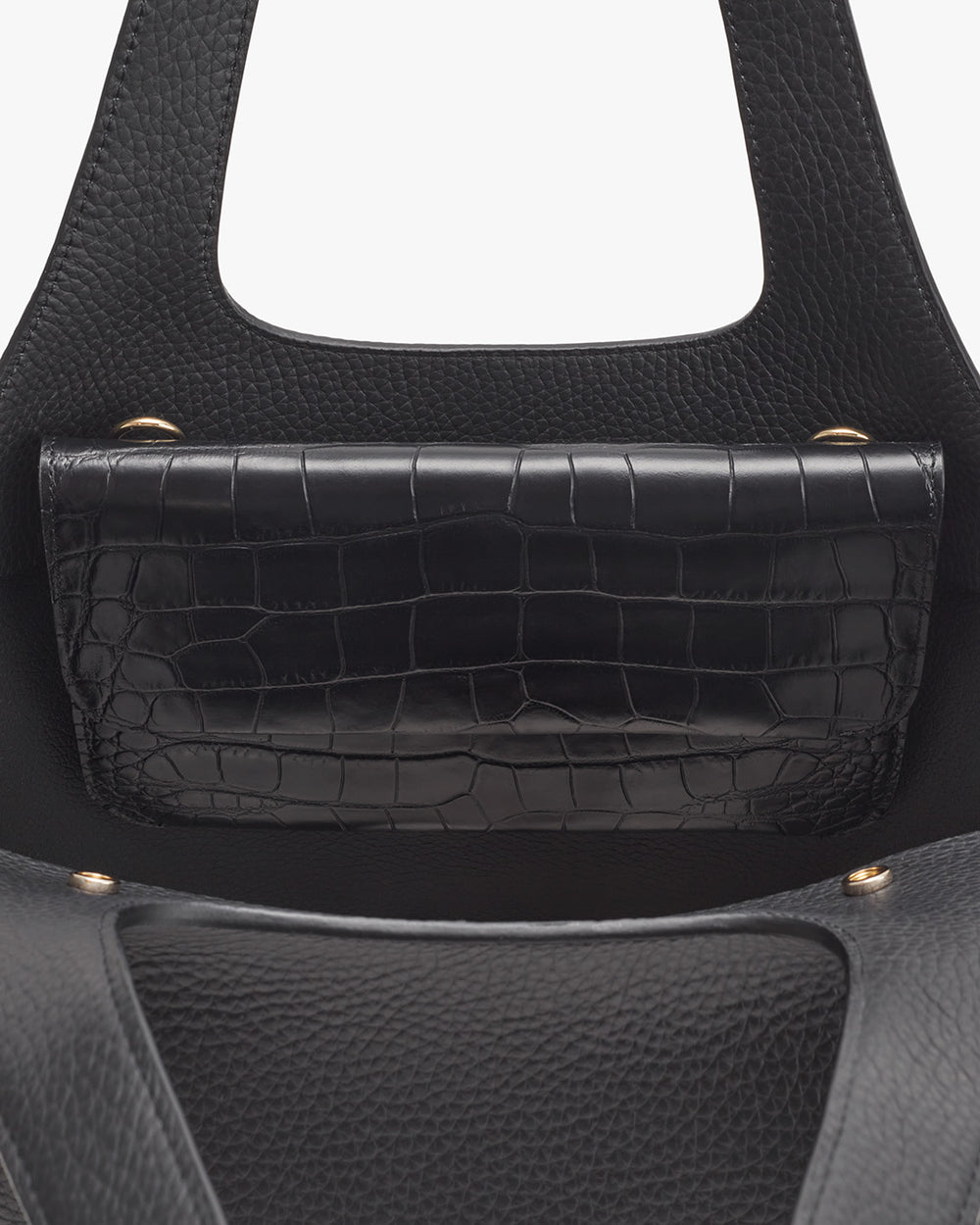 Close-up view of a handbag with a textured front pocket.
