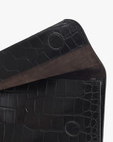 Close-up of a folded leather bag with a textured pattern.