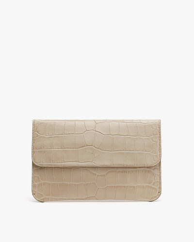 Croc-embossed leather clutch bag against a plain background.