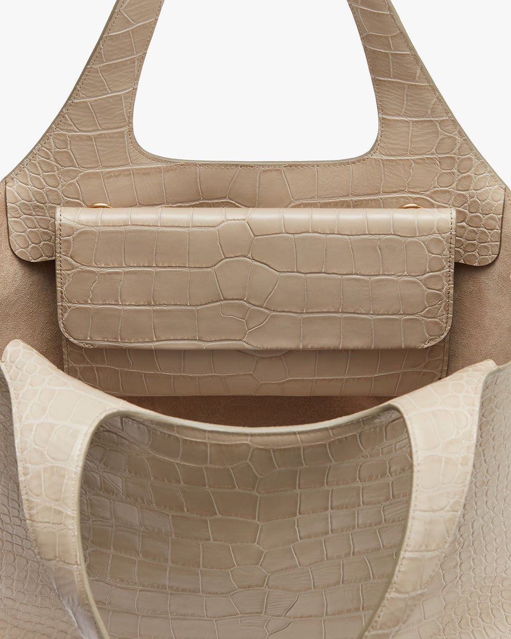 Two handbags with textured surface, one nested inside the other.