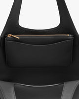 Close-up of a handbag with a zipper pocket.