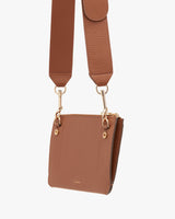 Handbag with adjustable shoulder strap and metal clasps.