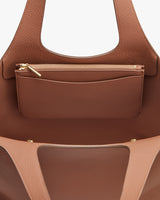 Open handbag with an attached small zipper pouch.