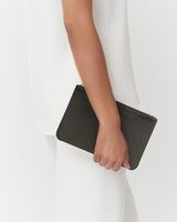 Person holding a clutch bag