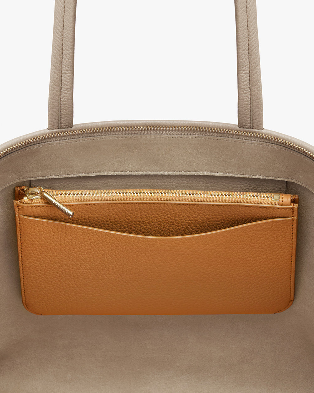 Close-up of a handbag with a zippered pocket.