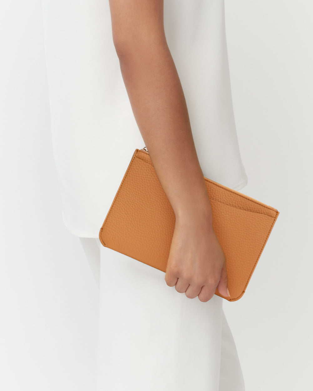 Person holding a small clutch bag