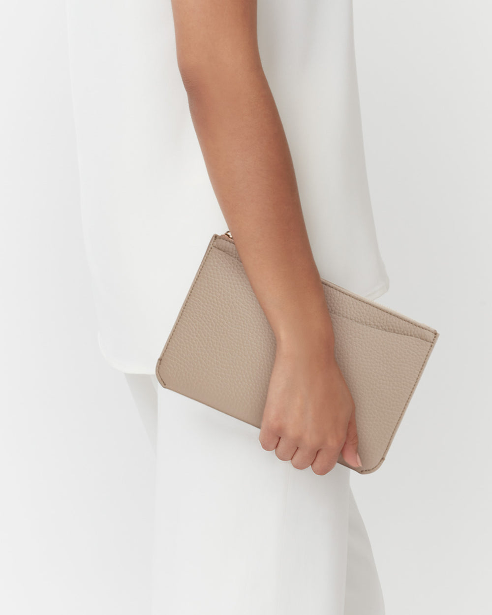 System Zipper Pouch Person holding a small clutch bag