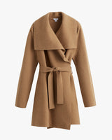 Coat with a belt and draped lapel on a plain background