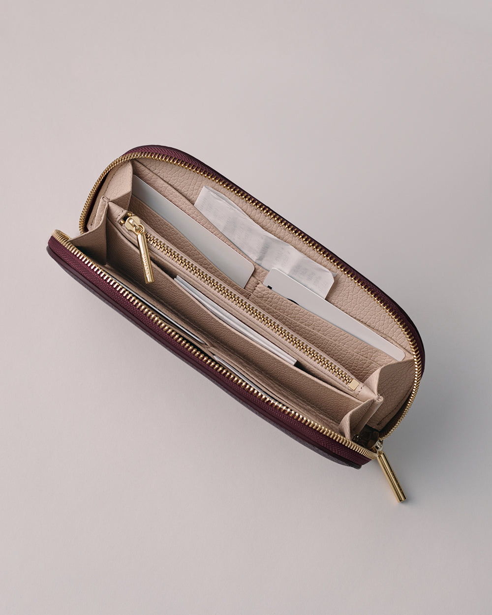 Curved Zip Wallet Wallet with open zipper, showing multiple compartments and pockets inside.