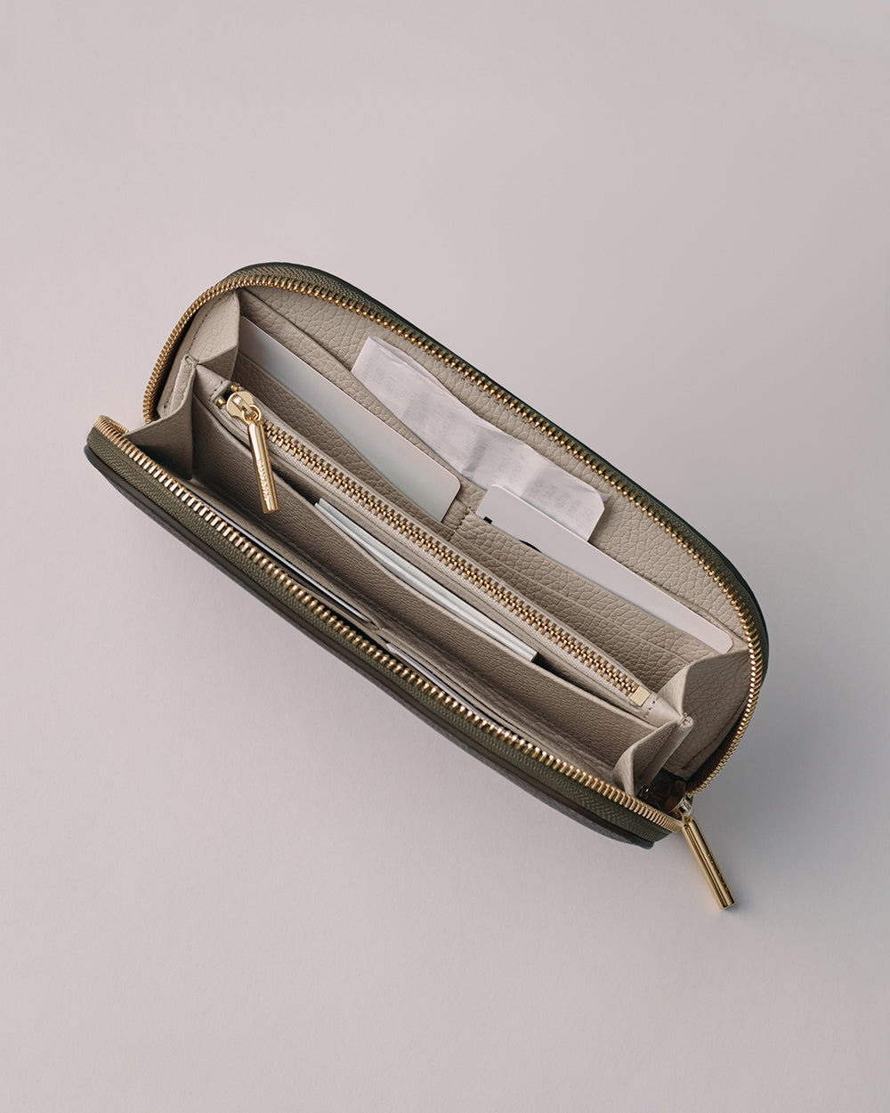 Curved Zip Wallet Open wallet with multiple compartments and sections for cards and zippers