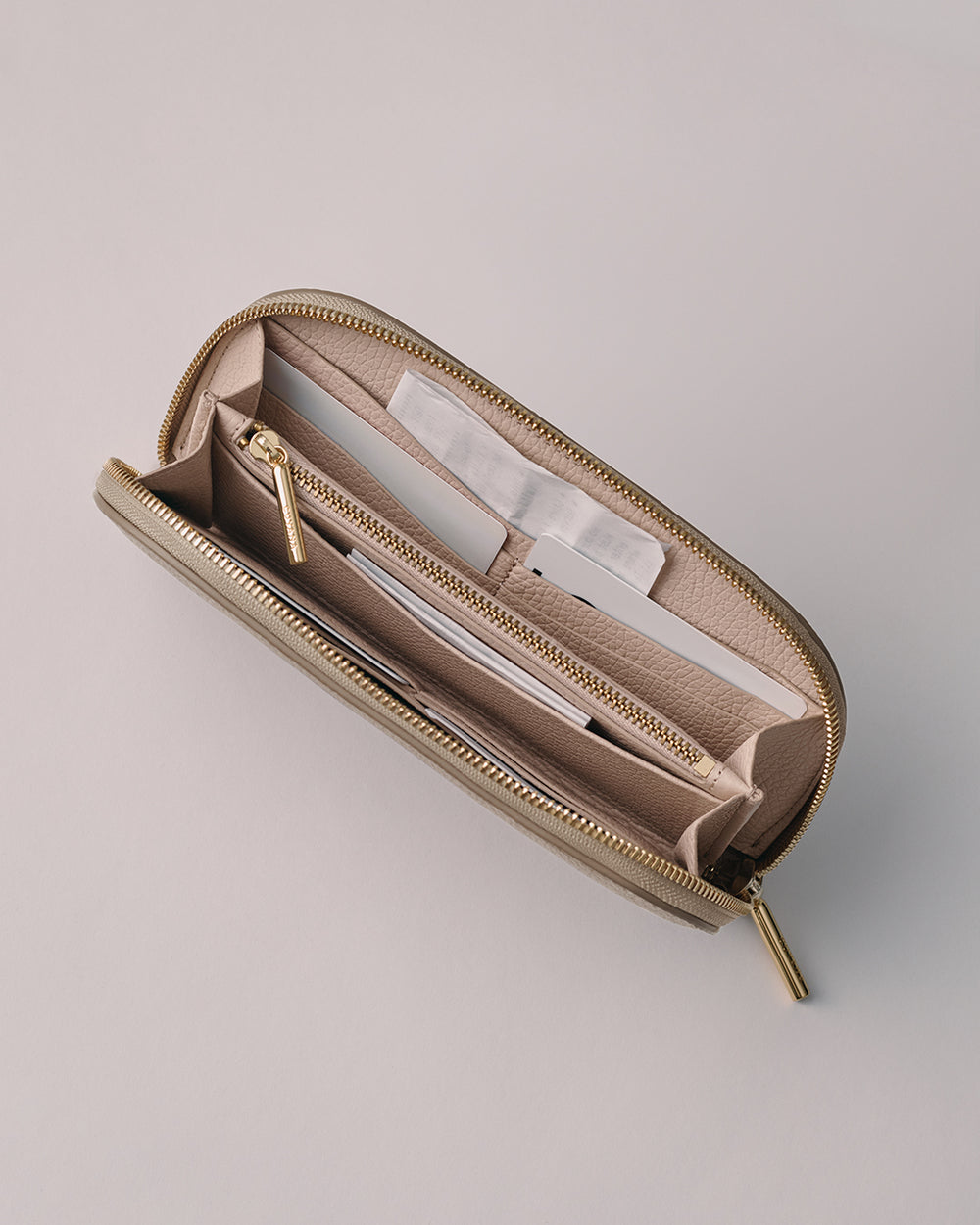Curved Zip Wallet Wallet with multiple sections and a zipper closure, viewed from above.