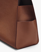 Textured leather tote bag with an exterior pocket