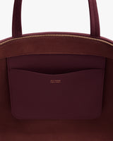 Open handbag with interior pocket and gold zipper detail