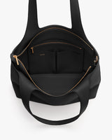 Open travel bag showing interior pockets and zippers