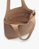 Open handbag with zipper pocket and two slots inside.