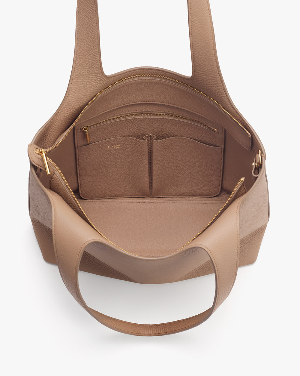 Open travel bag with multiple compartments and zippered pocket inside.