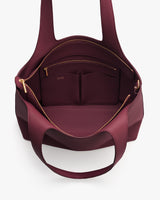 Open travel bag showing interior compartments and a zipper pocket.