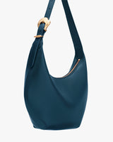 Shoulder bag with curved design and zipper closure.