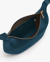 Open handbag with a gold zipper and interior pocket visible.