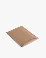 Rectangular leather laptop sleeve with a curved flap closure.