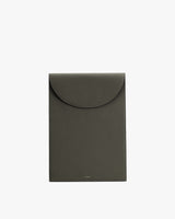 Rectangular leather laptop sleeve bag with a flap closure.