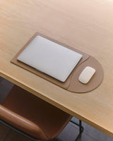 Laptop and mouse on a flattened laptop sleeve.