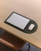 Laptop and mouse on a flattened laptop sleeve.