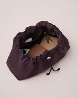 Open bag with wallet, keys, and phone inside.