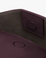 Inside view of an open leather bag with magnetic closures