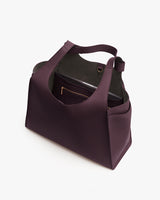 Open handbag with inner compartments and a visible zipper pocket.