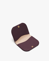 Small open wallet with button closure on a white background.