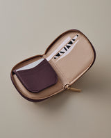 Open zippered wallet with card slots and a small pocket.