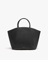 Handbag with two short handles on plain background