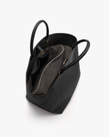 Open handbag with multiple compartments and handles visible