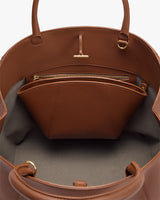 Open handbag with interior zip pocket and handles visible
