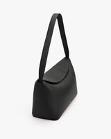 Shoulder bag with long strap on white background