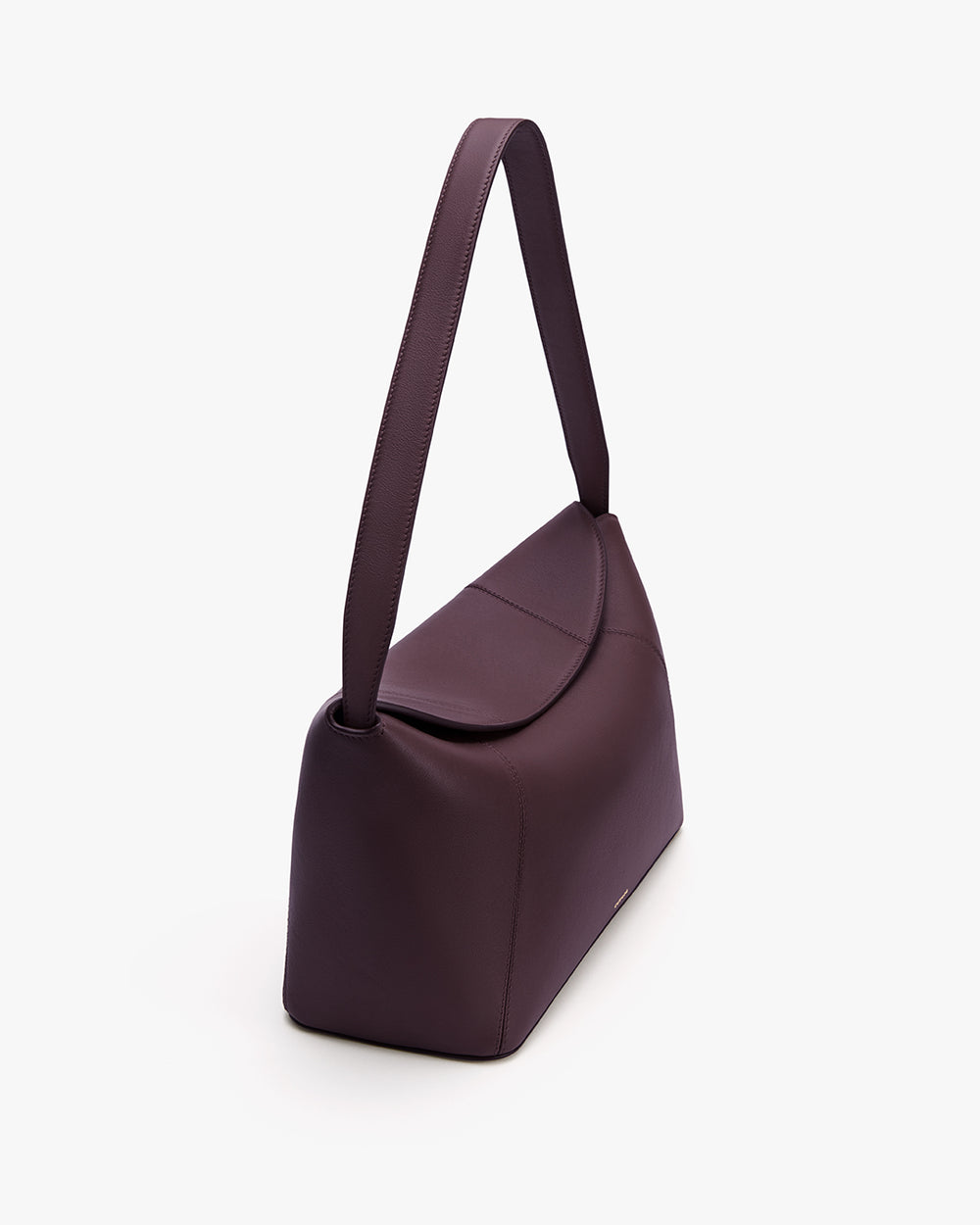 Shoulder bag with long strap and flap closure on white background.