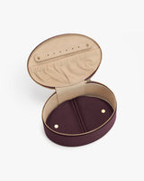 Open oval-shaped zippered case with compartments inside
