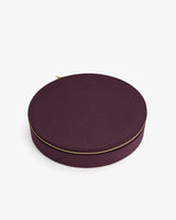 Round textured case with a zipper closure.