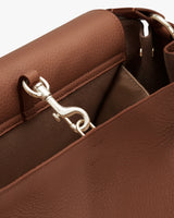 Close-up of a backpack's metal clasp and attachment.