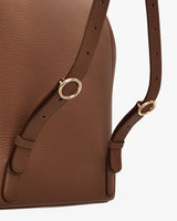 Backpack with adjustable straps and gold buckles