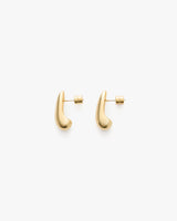 Pair of curved stud earrings on a plain background