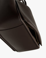 Close-up of a tote bag with a partially open zipper.