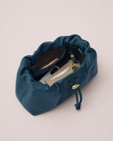 Open drawstring bag displaying items inside