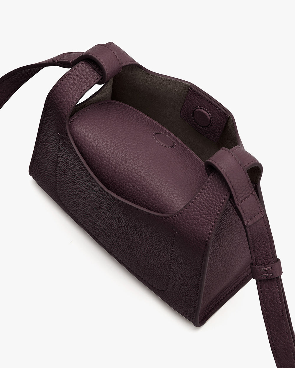 Mini Double Loop Bag A rectangular leather bag with an adjustable strap, magnetic top flap, and exterior